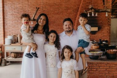 a family posing for a picture in a kitchen